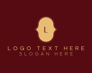 Gold Cursive Lettermark logo