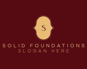 Gold Cursive Lettermark logo